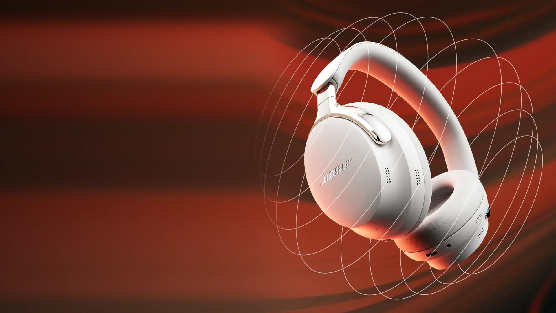 Bose QuietComfort Ultra Headphones blancos sobre fondo rojo
