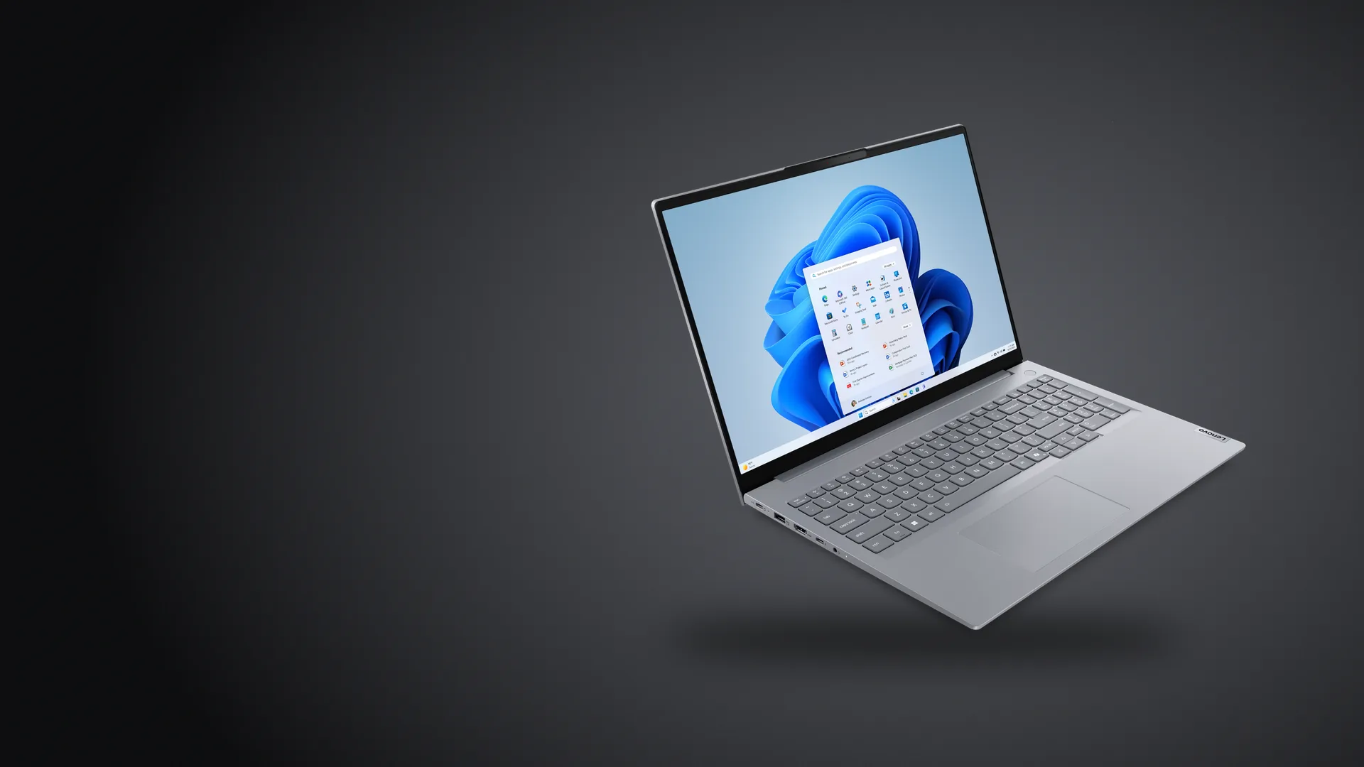 Notebook Lenovo ThinkBook 16 Gen 8 gris, abierta, sobre fondo grafito